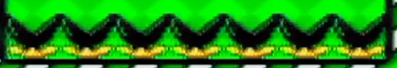 Screenshot: Reihe schwarzer Pflanzen mit spitzen Zähnen und gelben Augen auf grünem Gras